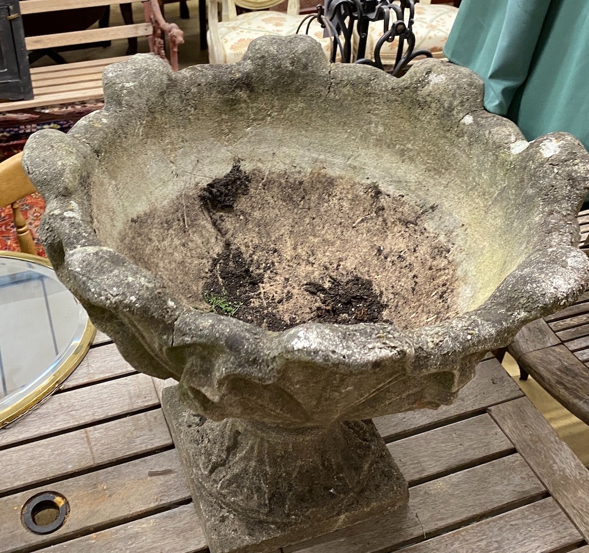 A pair reconstituted stone garden urns mounted with stylised leaves